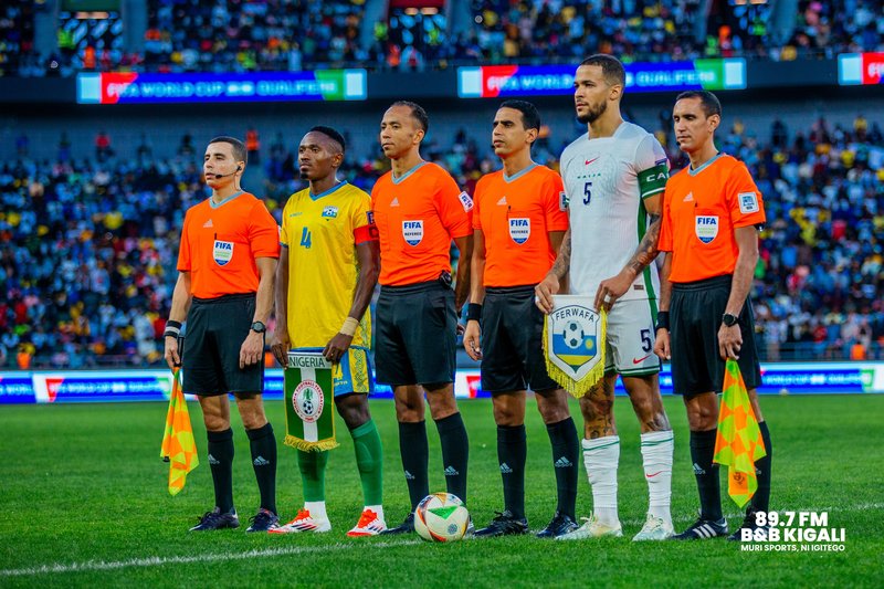 Both captains take photo with referees
